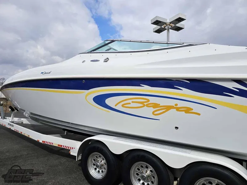 Slide: The Image of 2003 Baja .38 Special boat on trailer, featuring sleek design and vibrant graphics. - 12