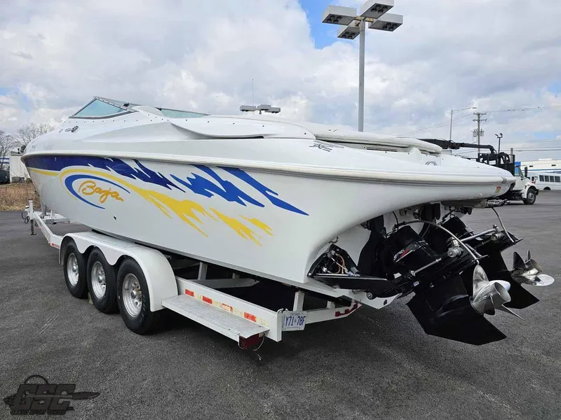 Slide: The Image of 2003 Baja .38 Special speedboat on trailer, featuring vibrant blue and yellow graphics. - 13