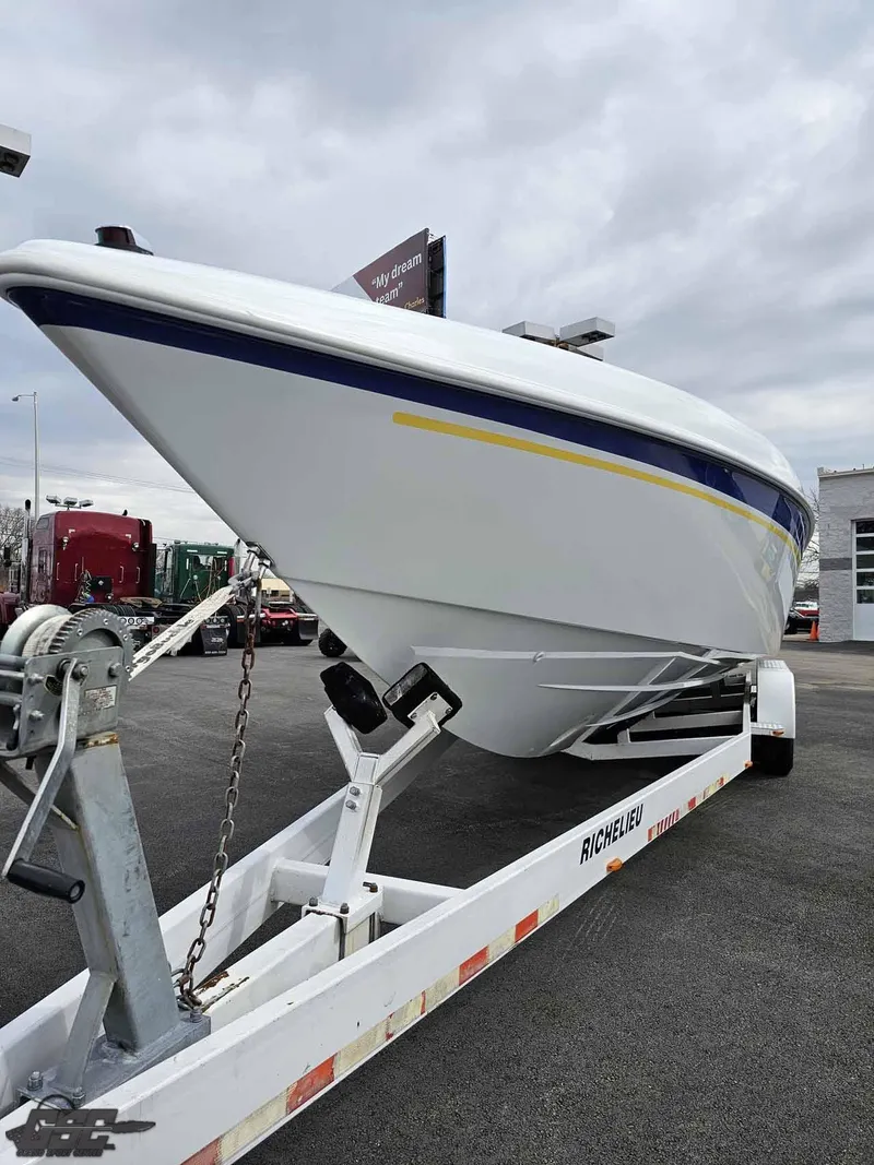 Slide: The Image of 2003 Baja .38 Special boat on trailer, parked outdoors under cloudy sky. - 15