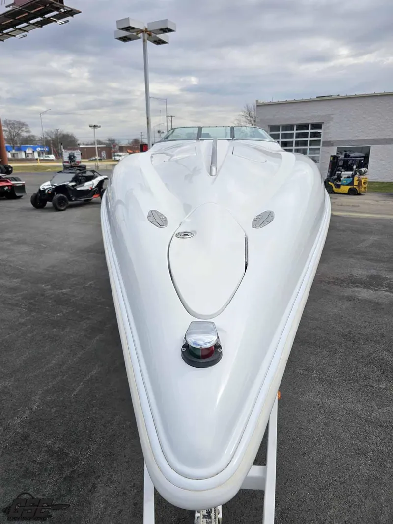 Slide: The Image of 2003 Baja .38 Special speedboat, sleek white design, parked outdoors under cloudy sky. - 16