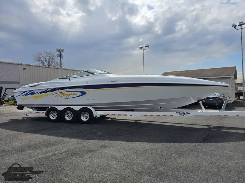 Slide: The Image of 2003 Baja .38 Special speedboat on trailer, parked outdoors under cloudy sky. - 18