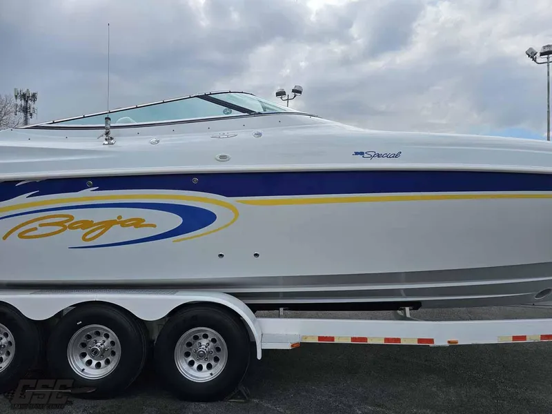 Slide: The Image of 2003 Baja .38 Special boat on trailer, featuring sleek design and vibrant graphics. - 22