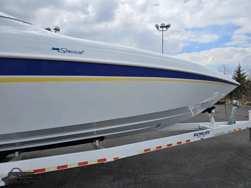 Slide: The Image of 2003 Baja .38 Special boat on trailer, featuring sleek white and blue design. - 23