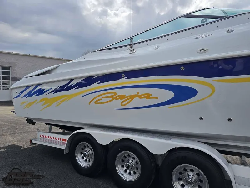 Slide: The Image of 2003 Baja .38 Special boat on trailer with vibrant blue and yellow graphics. - 24