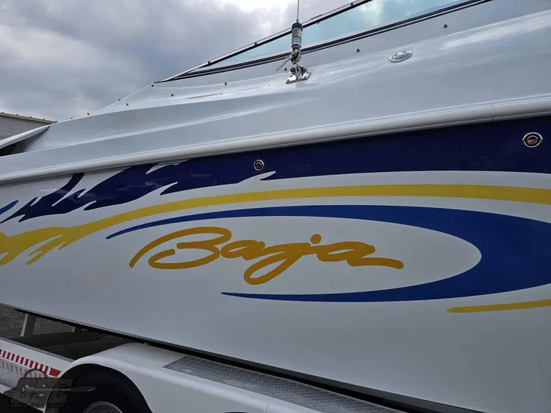 Slide: The Image of 2003 Baja .38 Special boat with blue and yellow graphics on the side. - 25