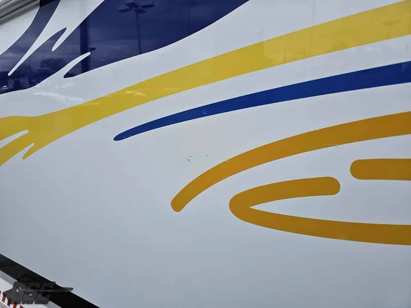 Slide: The Image of 2003 Baja .38 Special boat with blue and yellow graphic design. - 26