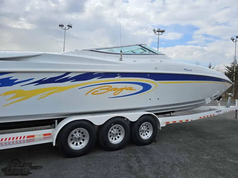 Slide: The Image of 2003 Baja .38 Special boat on trailer, featuring sleek design and vibrant graphics. - 28