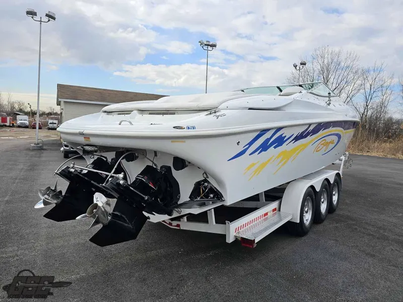 Slide: The Image of 2003 Baja .38 Special speedboat on trailer, featuring vibrant graphics and dual propellers. - 30