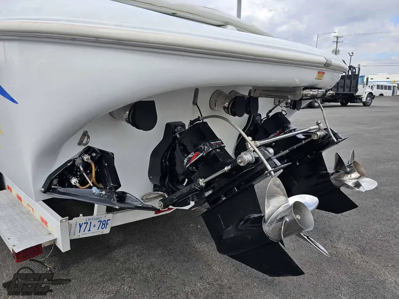 Slide: The Image of 2003 Baja .38 Special boat with dual propellers and outboard motors on a trailer. - 33