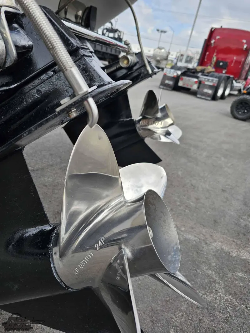 Slide: The Image of Close-up of a 2003 Baja .38 Special boat propeller, with a truck in the background. - 34
