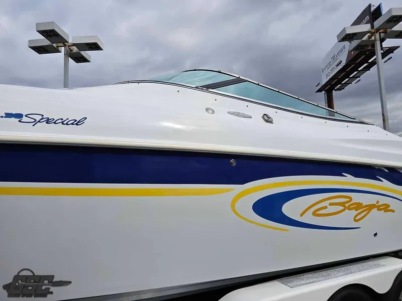 Slide: The Image of 2003 Baja .38 Special boat with blue and yellow accents under cloudy sky. - 7