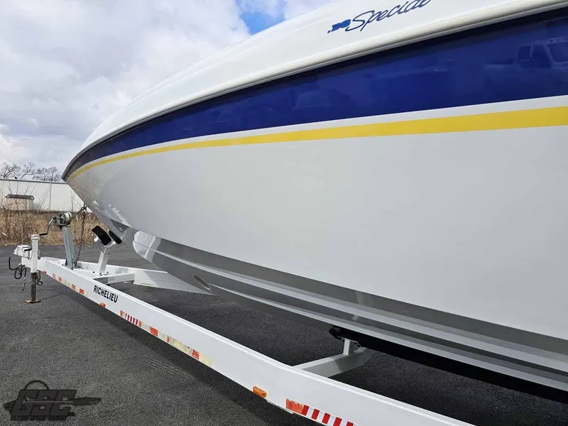Slide: The Image of 2003 Baja .38 Special boat on trailer, featuring sleek white and blue design. - 8