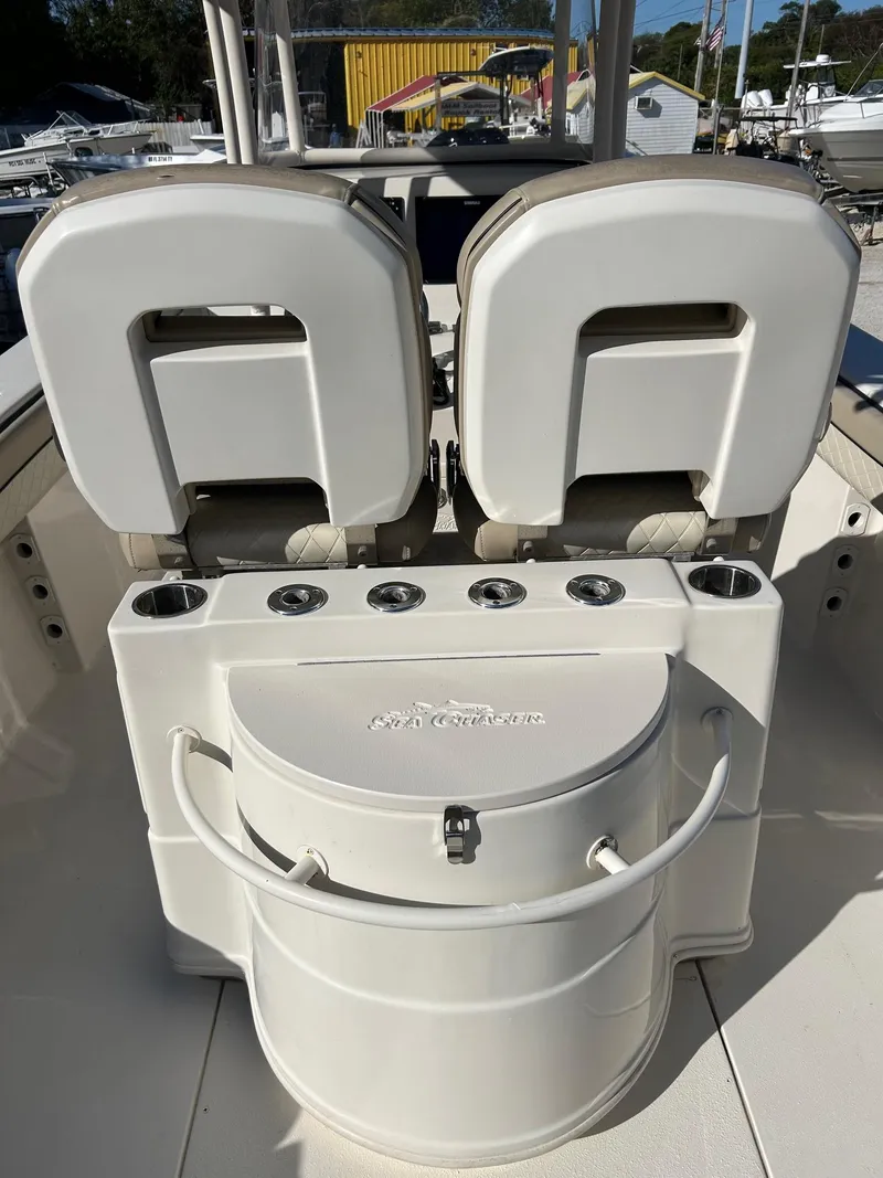 Slide: The Image of 2021 Sea Chaser 30 HFC DC boat seating and storage area with cup holders. - 4