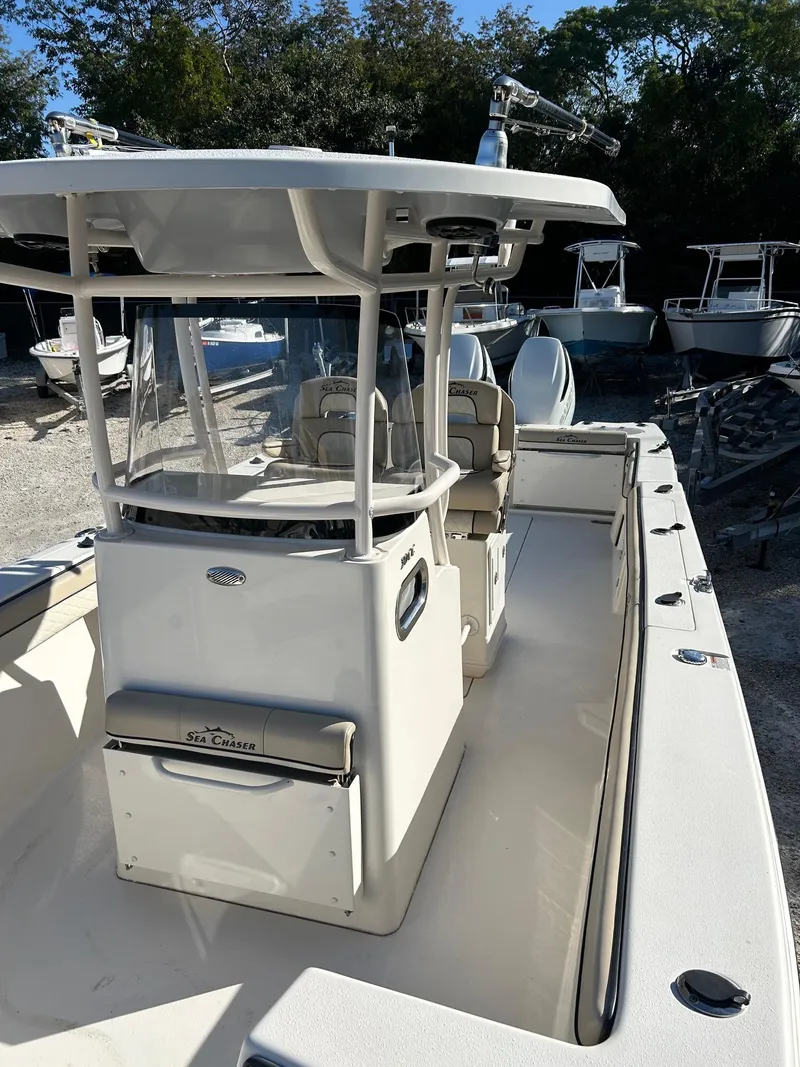 Slide: The Image of 2021 Sea Chaser 30 HFC DC boat with center console and seating, docked outdoors. - 7