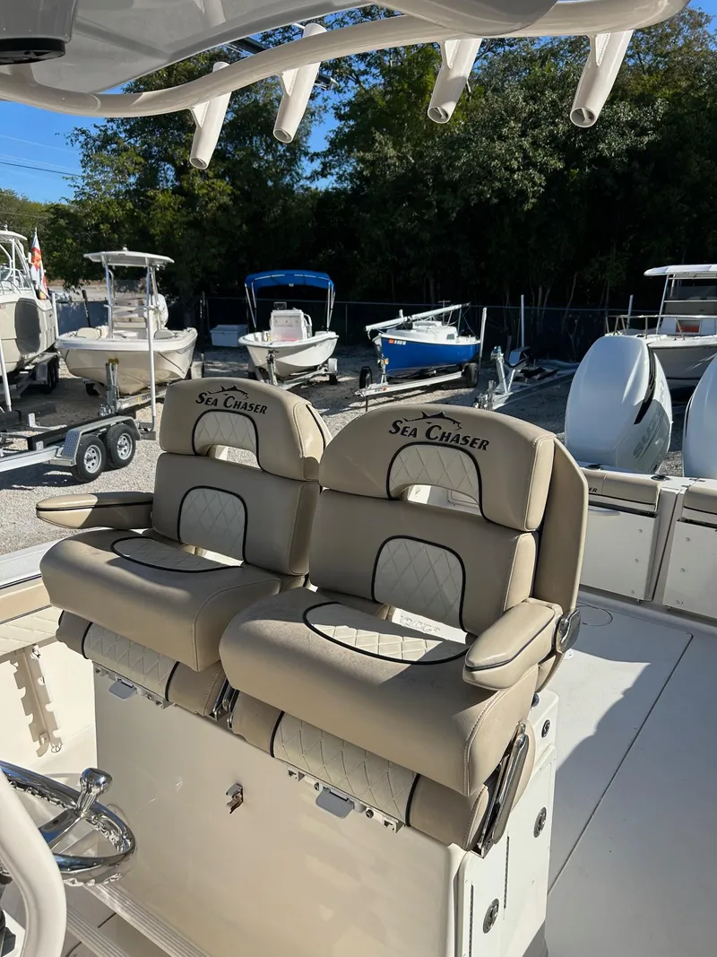 Slide: The Image of 2021 Sea Chaser 30 HFC DC boat with dual cushioned seats, docked outdoors. - 8