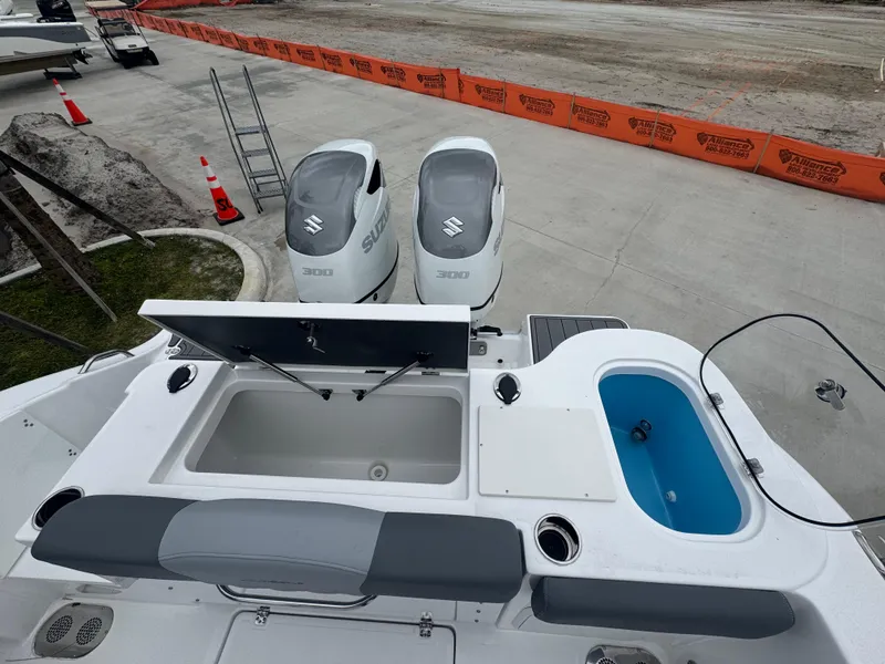 Slide: The Image of 2025 NauticStar 292 Legacy boat with dual Suzuki engines and open storage compartments. - 11