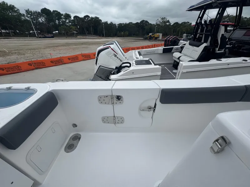 Slide: The Image of 2025 NauticStar 292 Legacy boat interior with seating and engine view. - 15