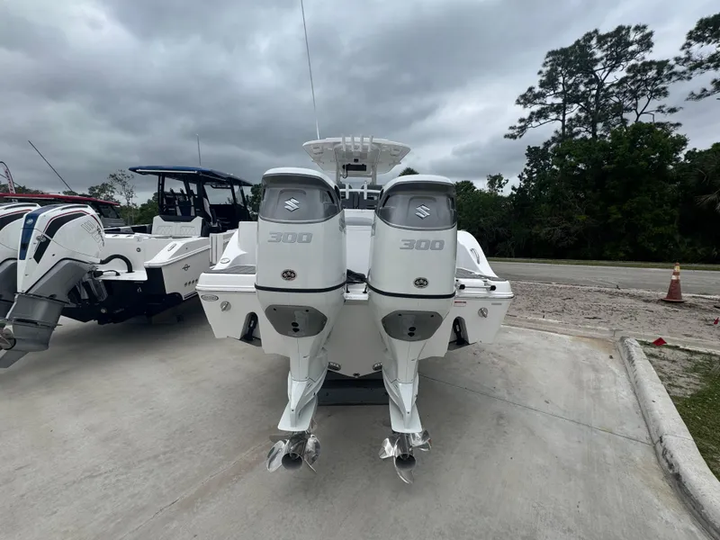 Slide: The Image of 2025 NauticStar 292 Legacy boat with dual 300 horsepower engines, parked outdoors. - 5