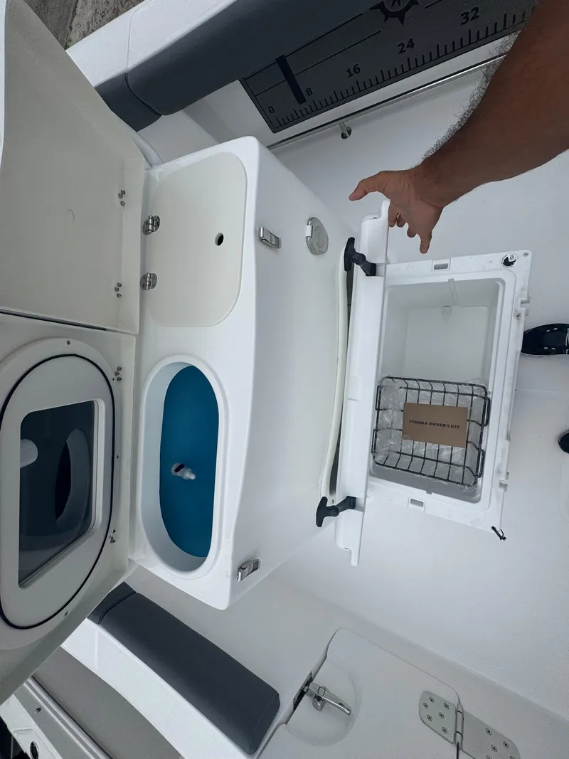 Slide: The Image of 2025 NauticStar 292 Legacy boat interior with storage compartments and livewell. - 8