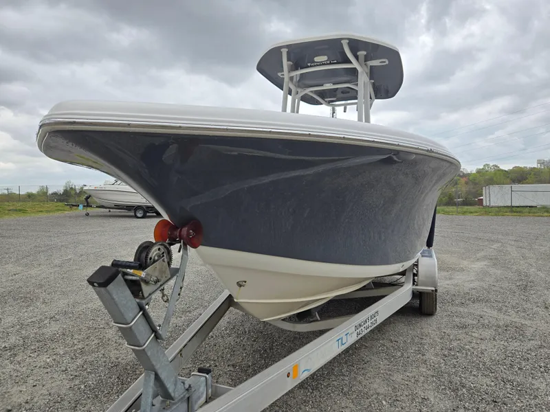 Slide: The Image of 2020 Tidewater 220 LXF boat on trailer, parked outdoors under cloudy sky. - 1