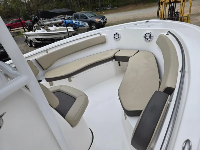 Slide: The Image of 2020 Tidewater 220 LXF boat interior with beige seating and speakers. - 14