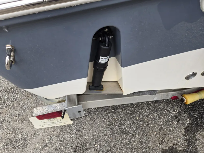 Slide: The Image of 2020 Tidewater 220 LXF boat on trailer, showing hydraulic component and hull detail. - 15