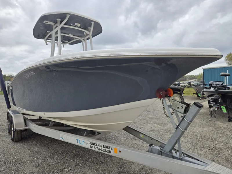 Slide: The Image of 2020 Tidewater 220 LXF boat on trailer under cloudy sky. - 2