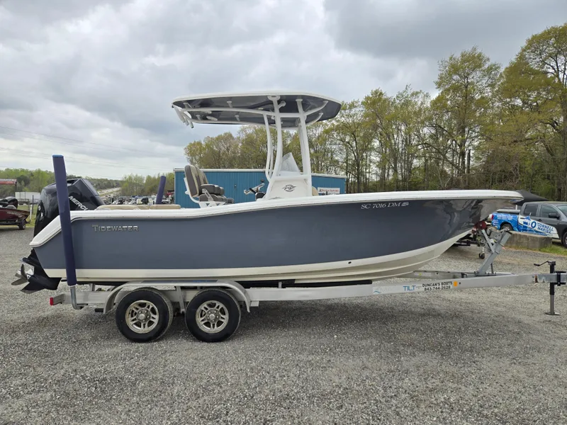 Slide: The Image of 2020 Tidewater 220 LXF boat on trailer, parked outdoors under cloudy sky. - 3
