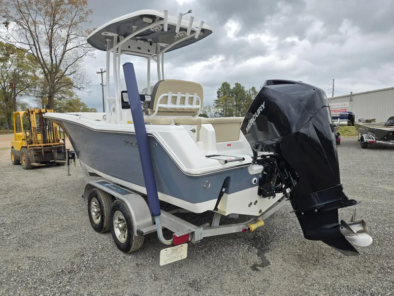 Slide: The Image of 2020 Tidewater 220 LXF boat on trailer, featuring a Mercury outboard motor. - 6