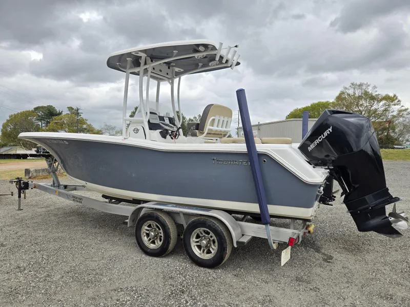 Slide: The Image of 2020 Tidewater 220 LXF boat on trailer with Mercury outboard motor, parked outdoors. - 7
