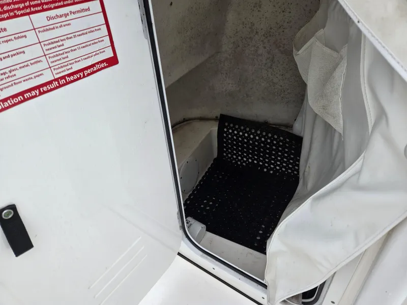 Slide: The Image of Interior view of 2020 Tidewater 220 LXF boat compartment with black mat and white curtain. - 9