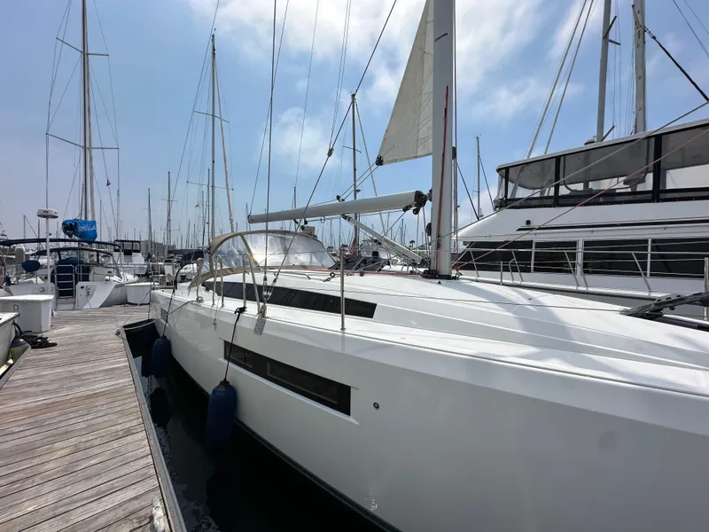 Slide: The Image of 2020 Jeanneau Sun Odyssey 410 sailboat docked at marina under clear sky. - 11
