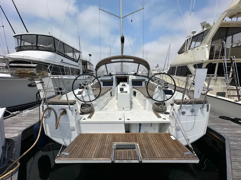 Slide: The Image of Jeanneau Sun Odyssey 410 sailboat, 2020 model, docked at a marina with dual steering wheels. - 13