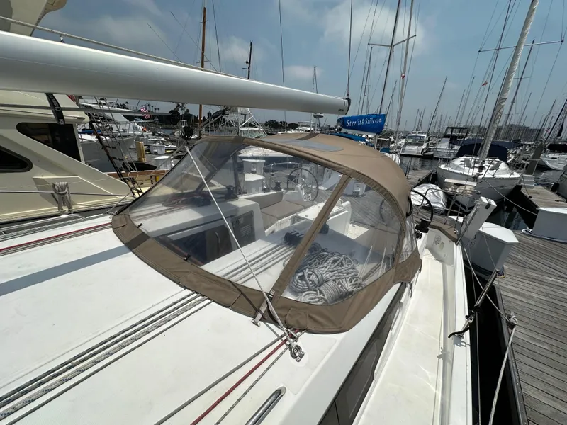 Slide: The Image of 2020 Jeanneau Sun Odyssey 410 sailboat docked at marina, featuring a tan cockpit cover. - 37