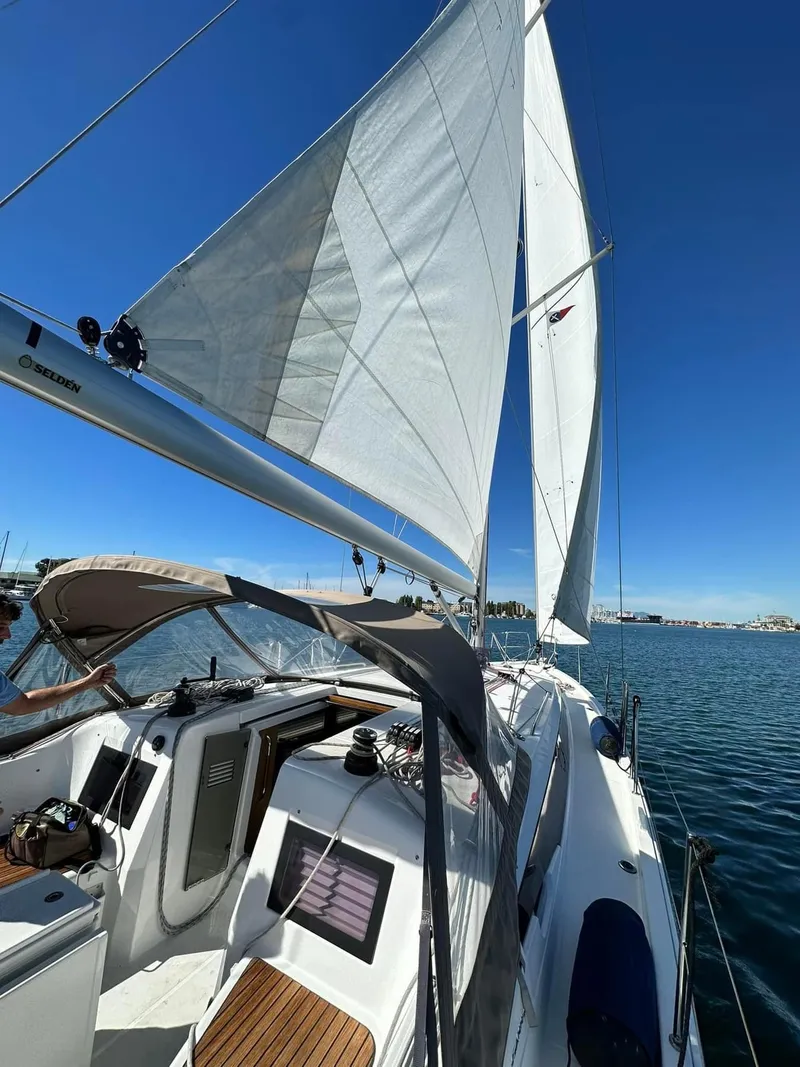 Slide: The Image of 2020 Jeanneau Sun Odyssey 410 sailing on a clear day with full sails. - 5