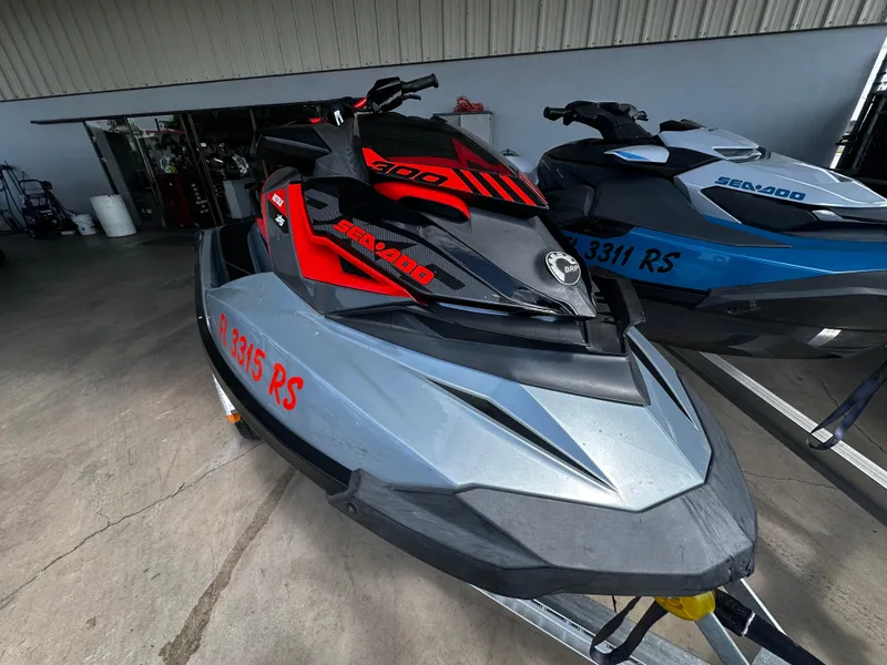 Slide: The Image of 2018 Sea-Doo RXP-X 300 jet ski in a showroom, featuring sleek red and black design. - 3