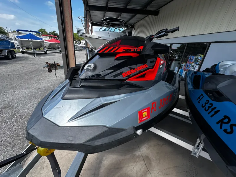 Slide: The Image of 2018 Sea-Doo RXP-X 300 jet ski in a showroom, featuring sleek design and vibrant colors. - 4