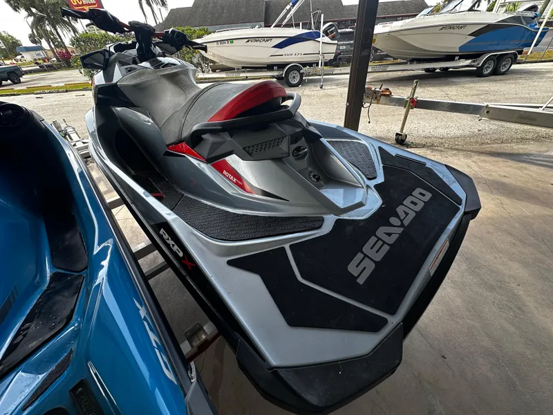 Slide: The Image of 2018 Sea-Doo RXP-X 300 jet ski in a marina setting. - 5