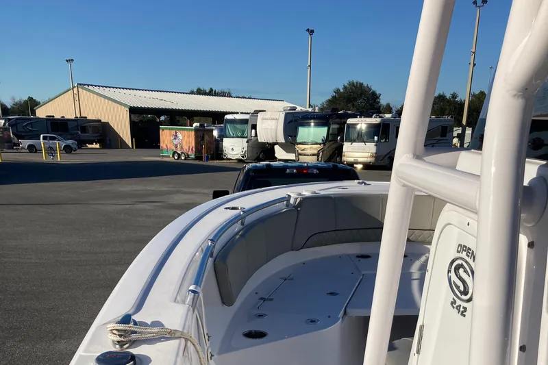 Slide: The Image of 2023 Sportsman Open 242 Center Console boat in a parking lot with RVs. - 10