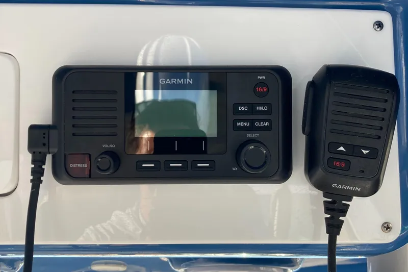 Slide: The Image of Garmin marine radio and microphone on 2023 Sportsman Open 242 Center Console boat. - 15