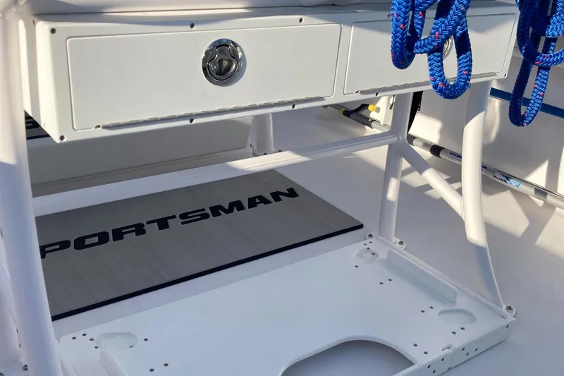 Slide: The Image of 2023 Sportsman Open 242 Center Console interior with storage and blue ropes. - 17