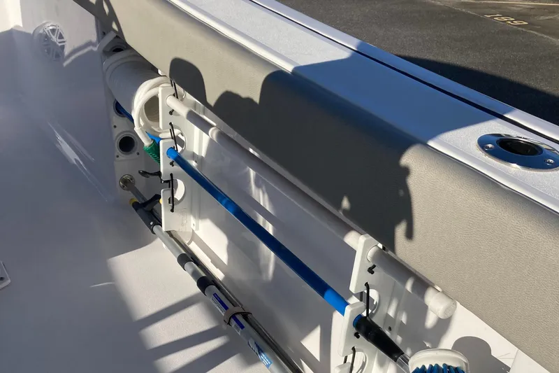 Slide: The Image of 2023 Sportsman Open 242 Center Console boat interior with rod holders and seating. - 18