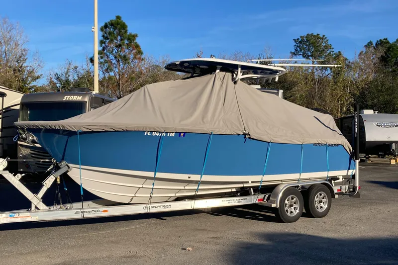 Slide: The Image of 2023 Sportsman Open 242 Center Console boat covered on trailer. - 5