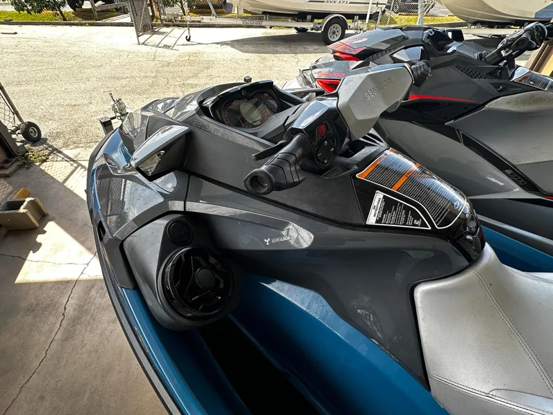 Slide: The Image of 2018 Sea-Doo GTX 230 jet ski in a showroom, showcasing sleek design and controls. - 5