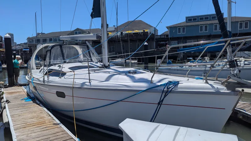 Slide: The Image of 1999 Hunter 380 sailboat docked at marina with clear blue sky. - 0