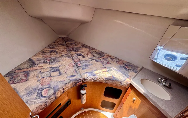 Slide: The Image of Interior cabin of 1999 Hunter 380 sailboat with bed, sink, and storage. - 17