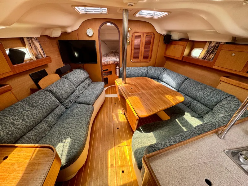 Slide: The Image of Interior of a 1999 Hunter 380 sailboat with cozy seating and wooden finishes. - 18