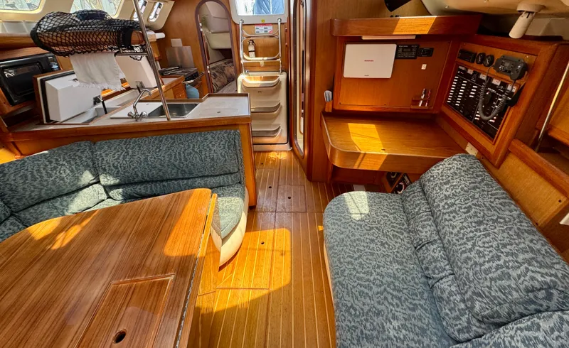 Slide: The Image of Interior of a 1999 Hunter 380 sailboat with wood finish and cozy seating. - 19