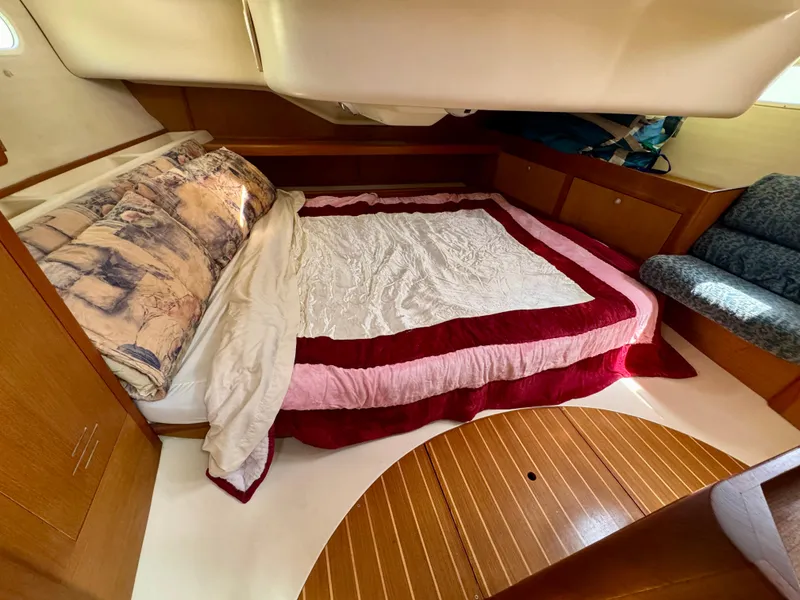 Slide: The Image of Cozy cabin interior of 1999 Hunter 380 sailboat with bed and seating area. - 27