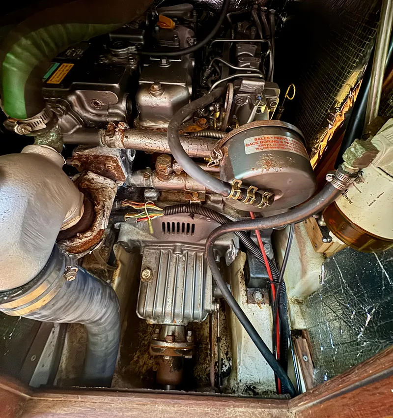 Slide: The Image of Engine compartment of a 1999 Hunter 380 sailboat, showcasing mechanical components and wiring. - 30